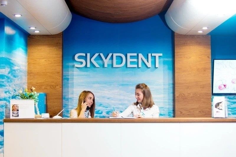 Reception desk of the Skydent dental clinic with two receptionists